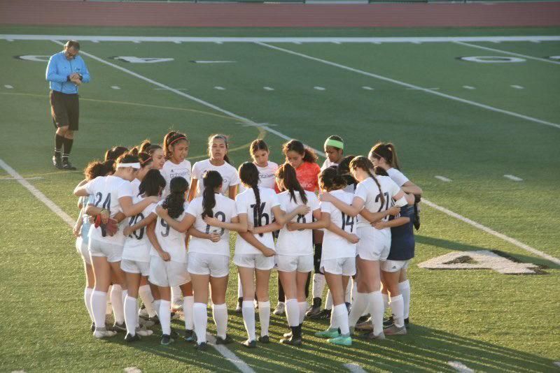 GATHERING MOTIVATION  Huddled up, the Eagles prepare to communicate during a tough game.