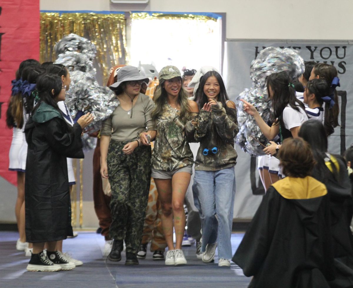 SAFARI CELEBRATION Dressed in camo and animal onesies, girls golf enters surrounded by cheers pom poms.