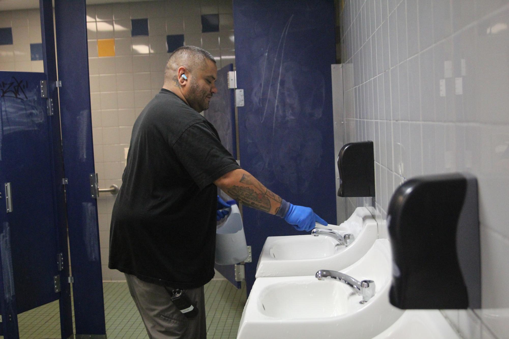 Maldonado cleans the boys restroom in the lower E building