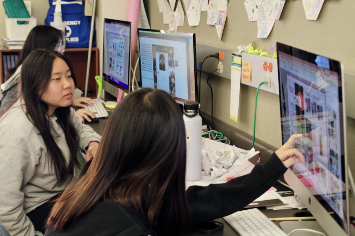  Editor-in-Chief Noelle Chan (right) and Photo Editor Cassy Liu (left) put the final touches on the yearbook pages. 