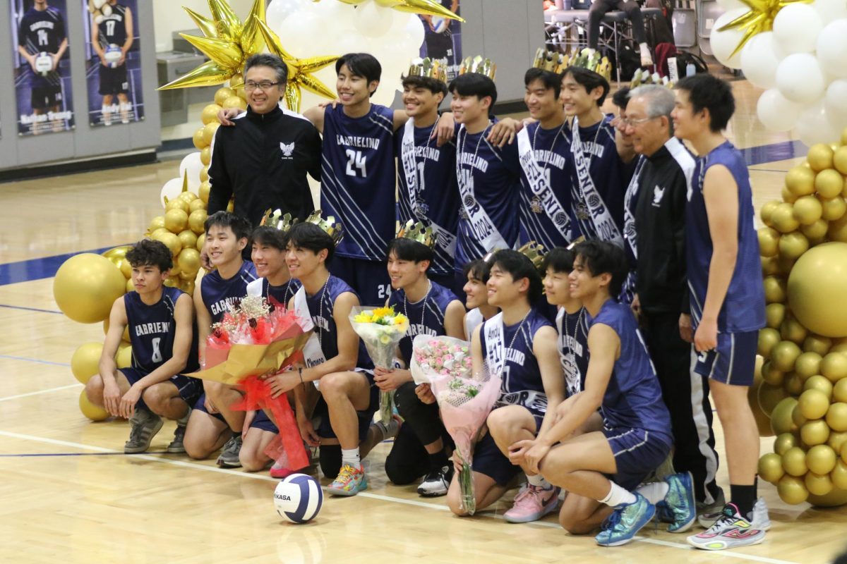 Boys volleyball team poses for photos.