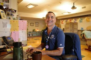 Chris Saporito, Wellness Center Coordinator, working at his desk at the Wellness Center. 