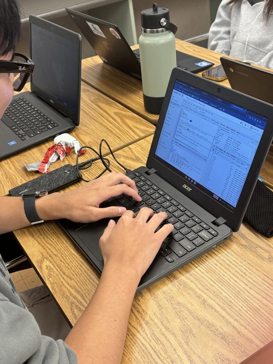 CRUNCHING NUMBERS- Senior Kenneth Chau crunches down election data. 