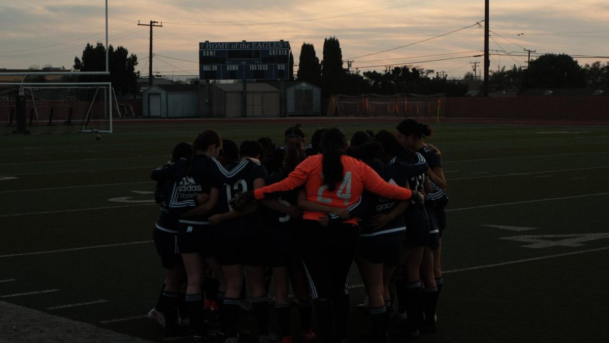 Varsity Girls Soccer huddles before their senior night match. 