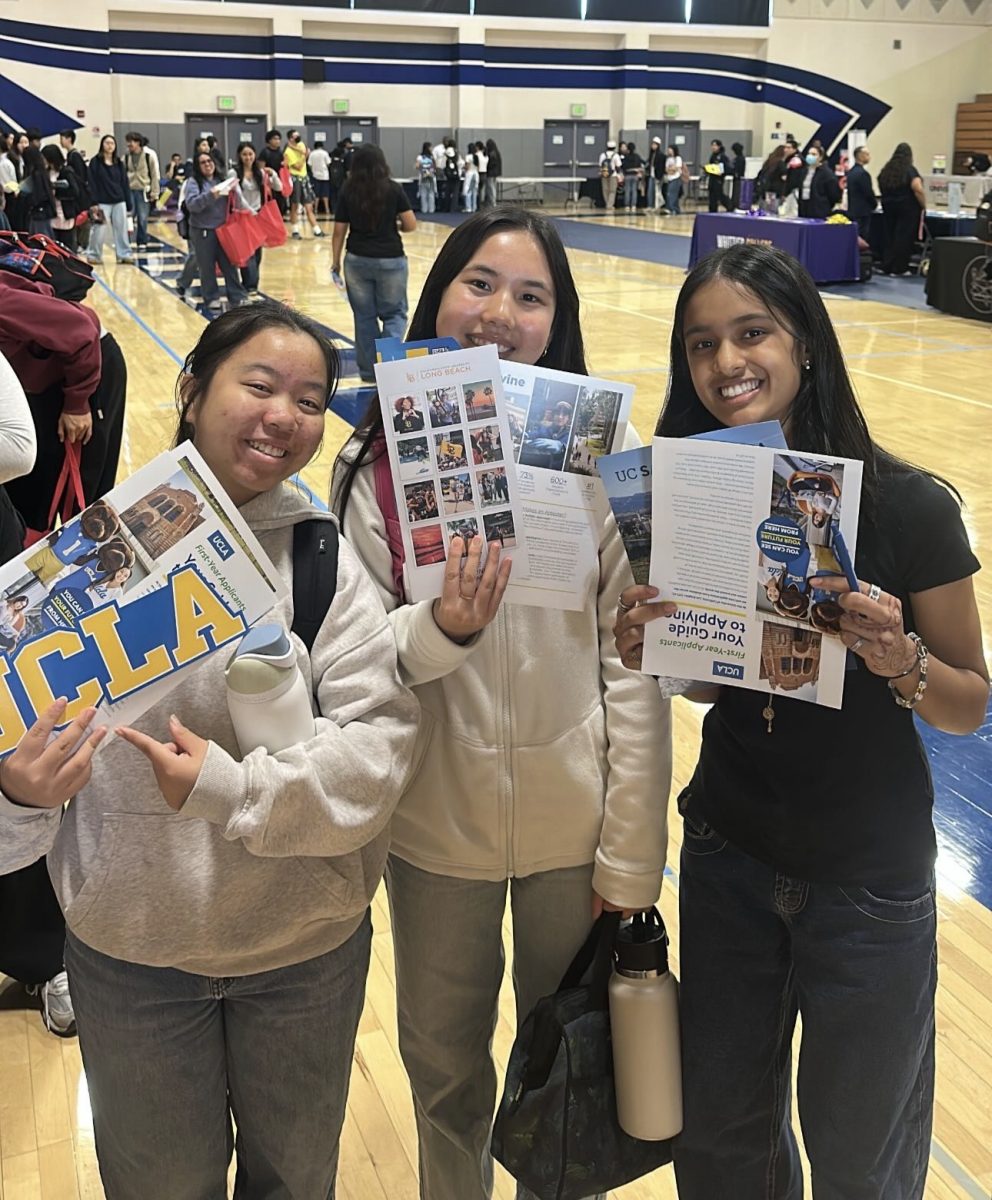 Students attend the college fair held in gym, learning more about universities such as UCLA, UC Irvine, and CSU Santa Barbara