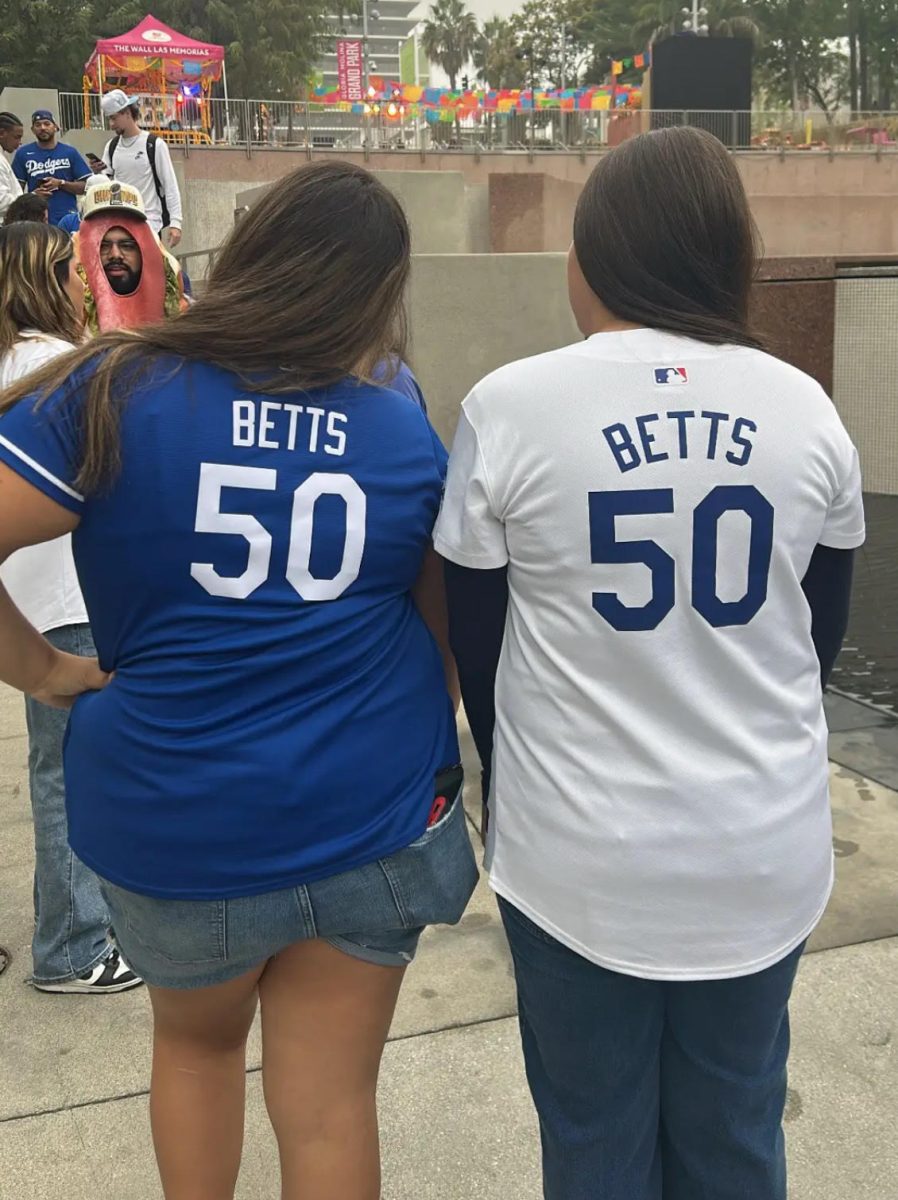 Freshman Raelene Macias (right) shows her Dodgers pride as she and another fan arrive early for the championship parade.