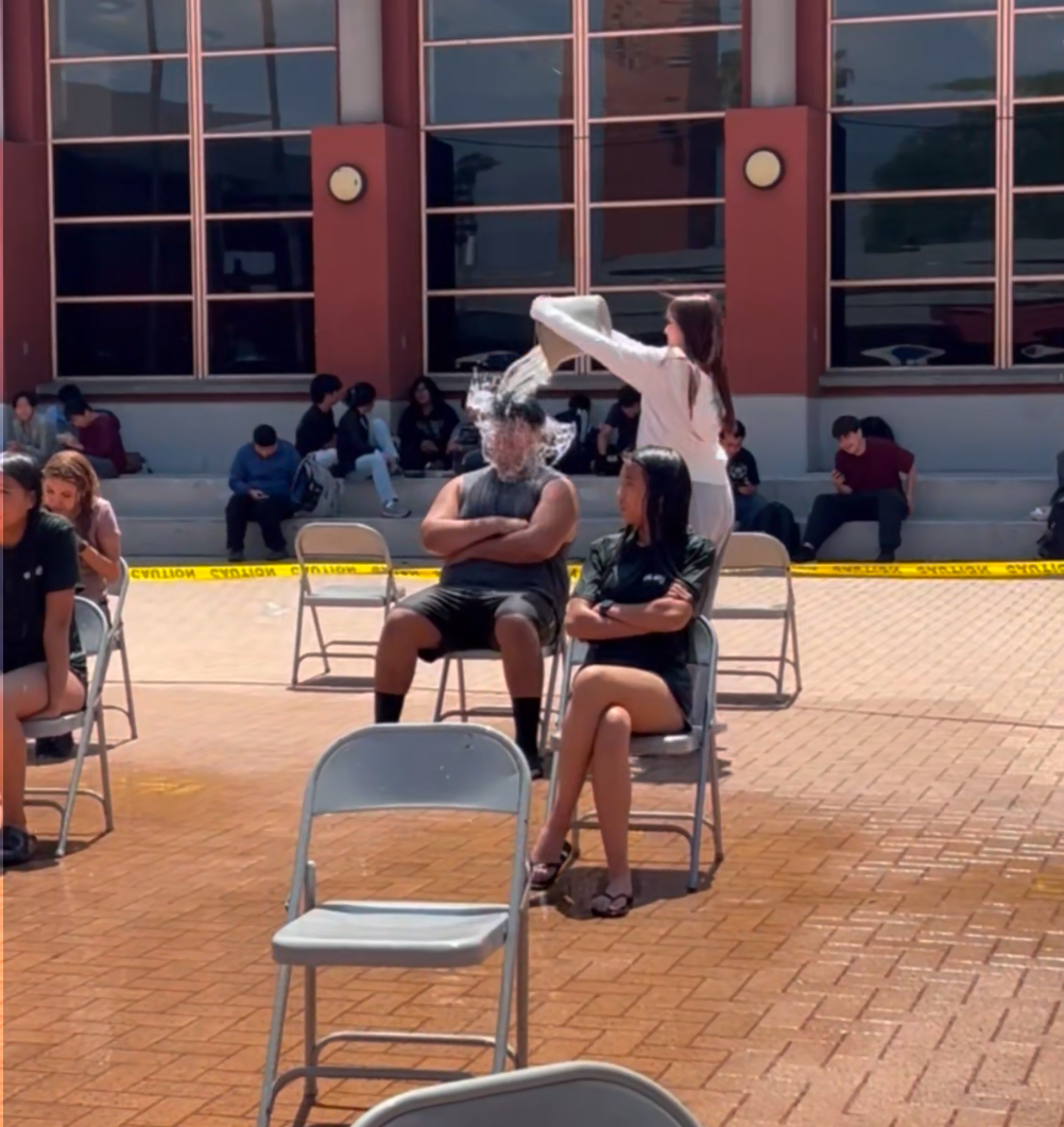 Michelle Cazares uses her first bucket to soak Gabriel Beltran.